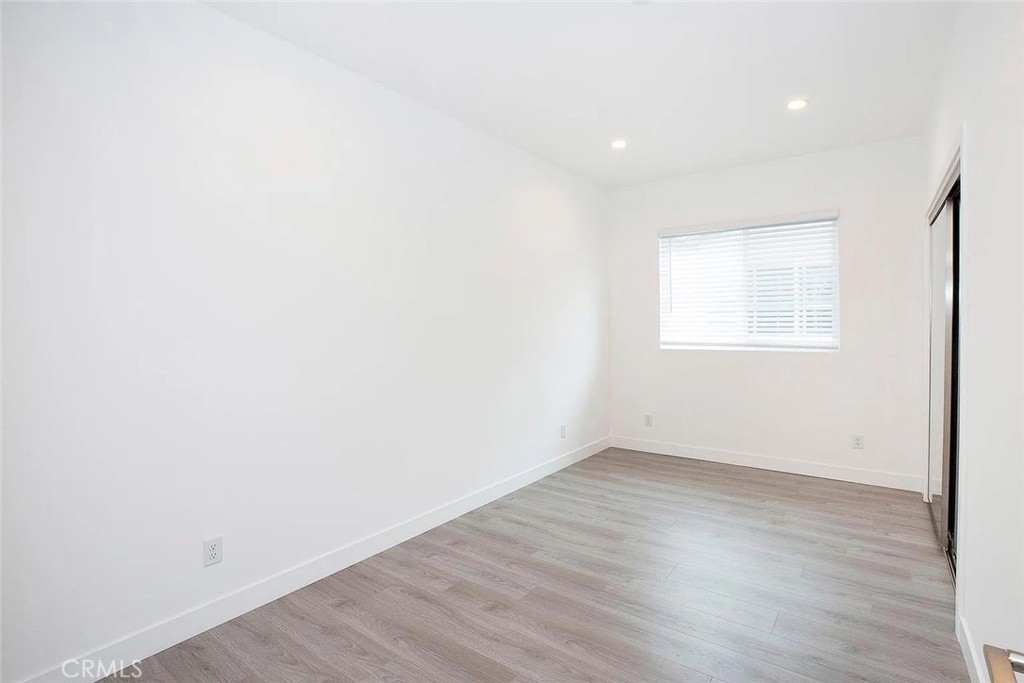 5026 1/2 Cleon Avenue North Hollywood, CA 91601 - Photo 11 of 19 an empty room with wooden floor and windows