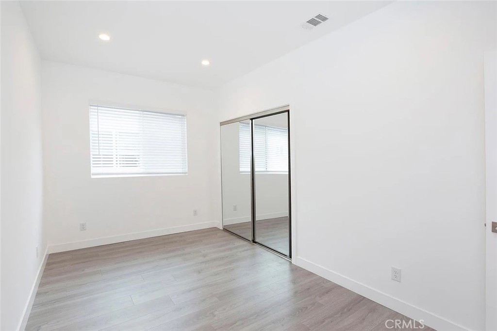 5026 1/2 Cleon Avenue North Hollywood, CA 91601 - Photo 9 of 19 an empty room with wooden floor and windows