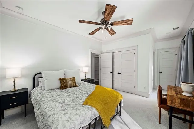 an aerial view of a house with garden space and a tree