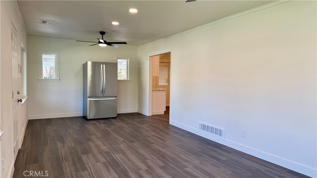 4542 Bandini Avenue Riverside, CA 92506 - Photo 8 of 22 a view of a hallway with wooden floor and a ceiling fan