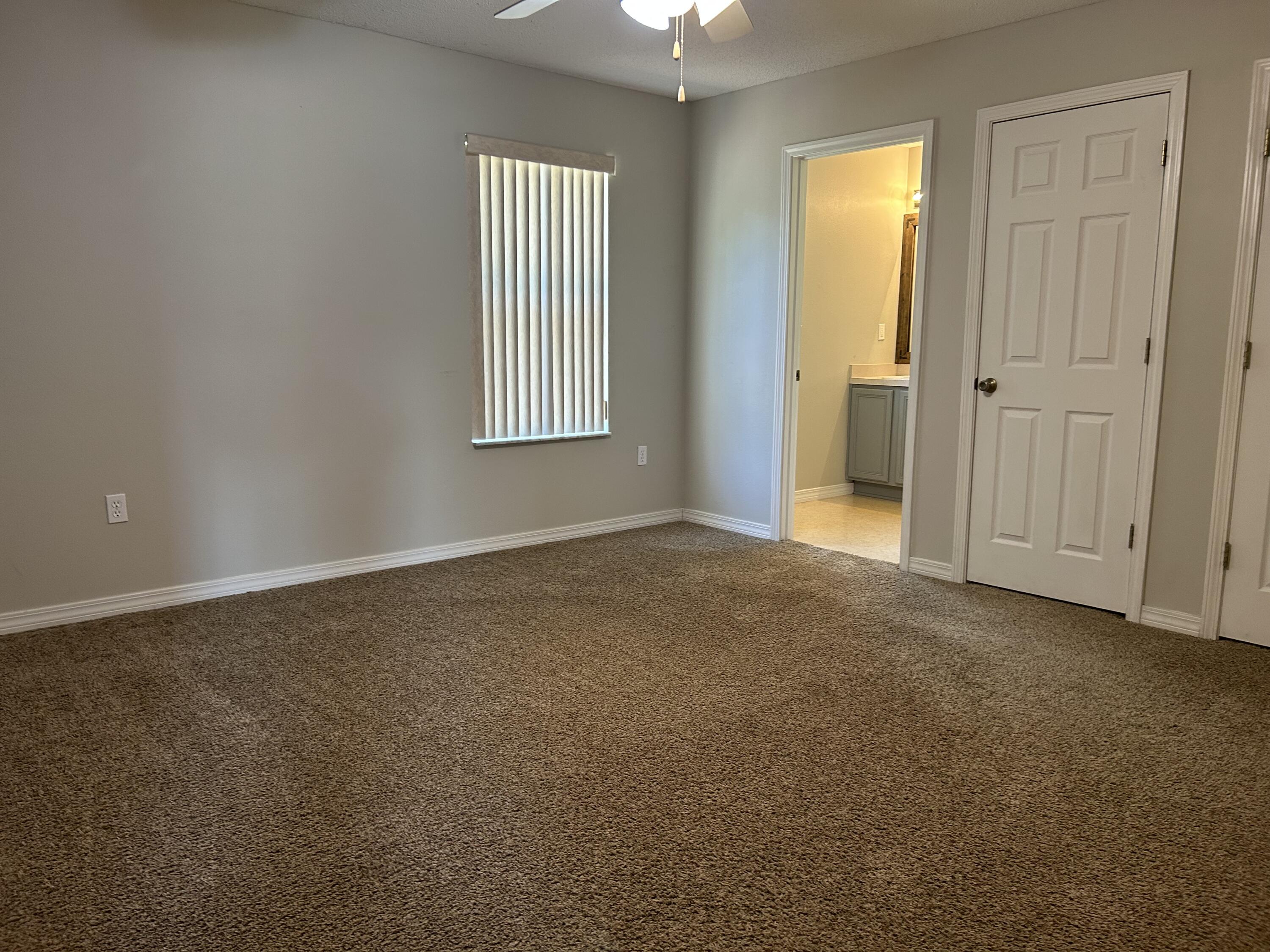 203 Cabana Way Crestview, FL 32536 - Photo 11 of 25 an empty room with windows and entrance to other room
