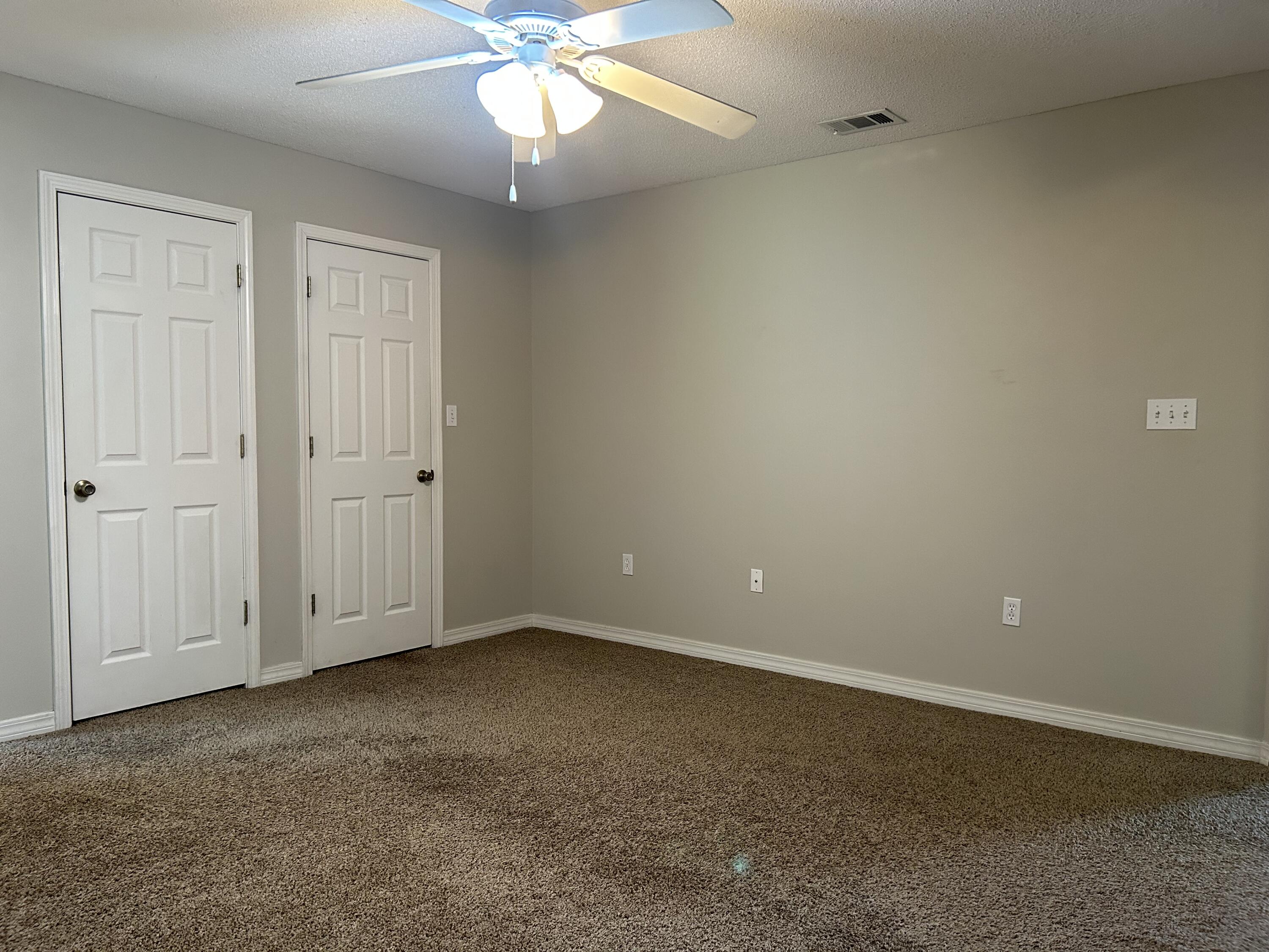 203 Cabana Way Crestview, FL 32536 - Photo 12 of 25 an empty room with a ceiling fan and a window