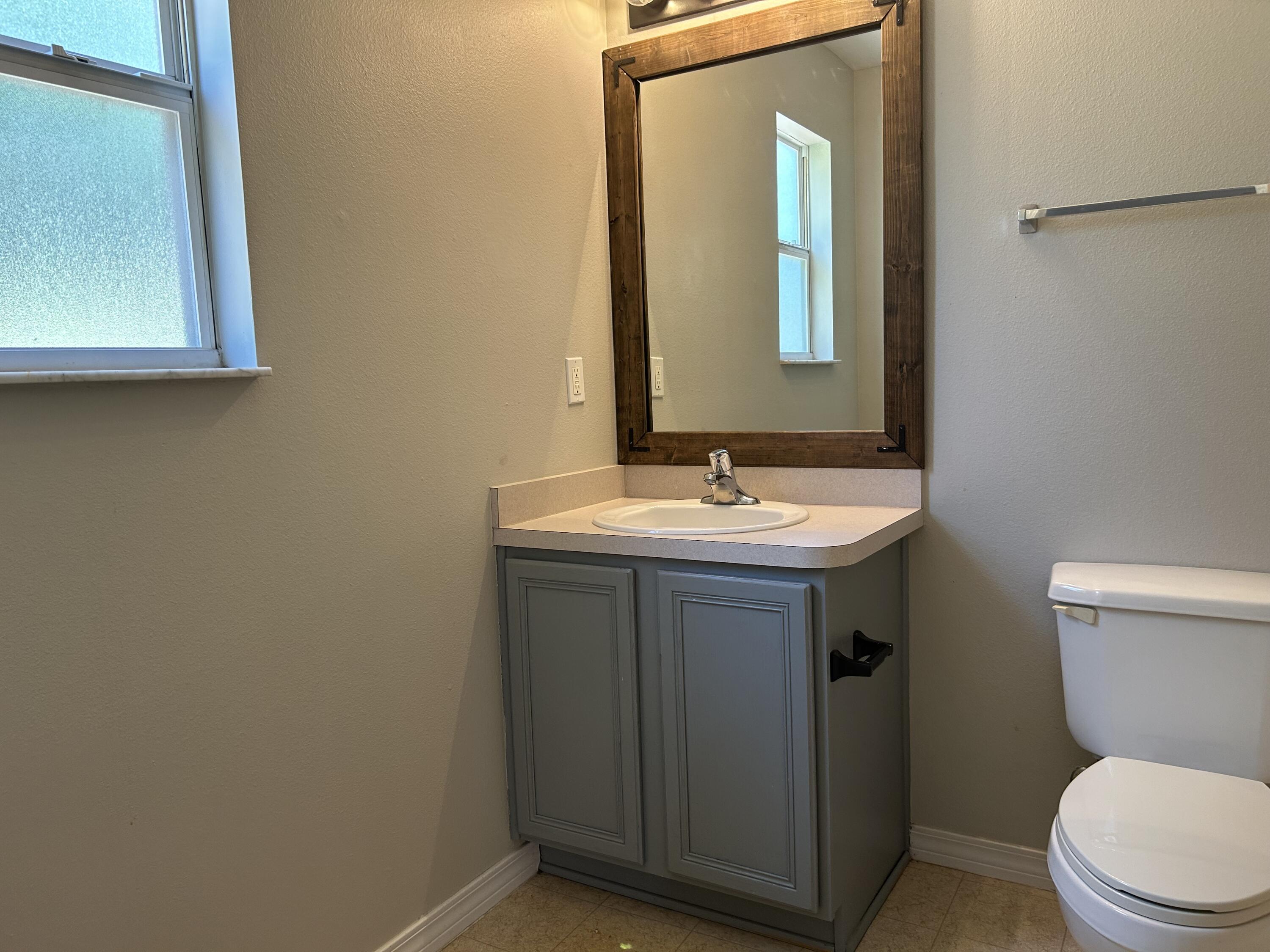 203 Cabana Way Crestview, FL 32536 - Photo 15 of 25 a bathroom with a toilet sink and mirror