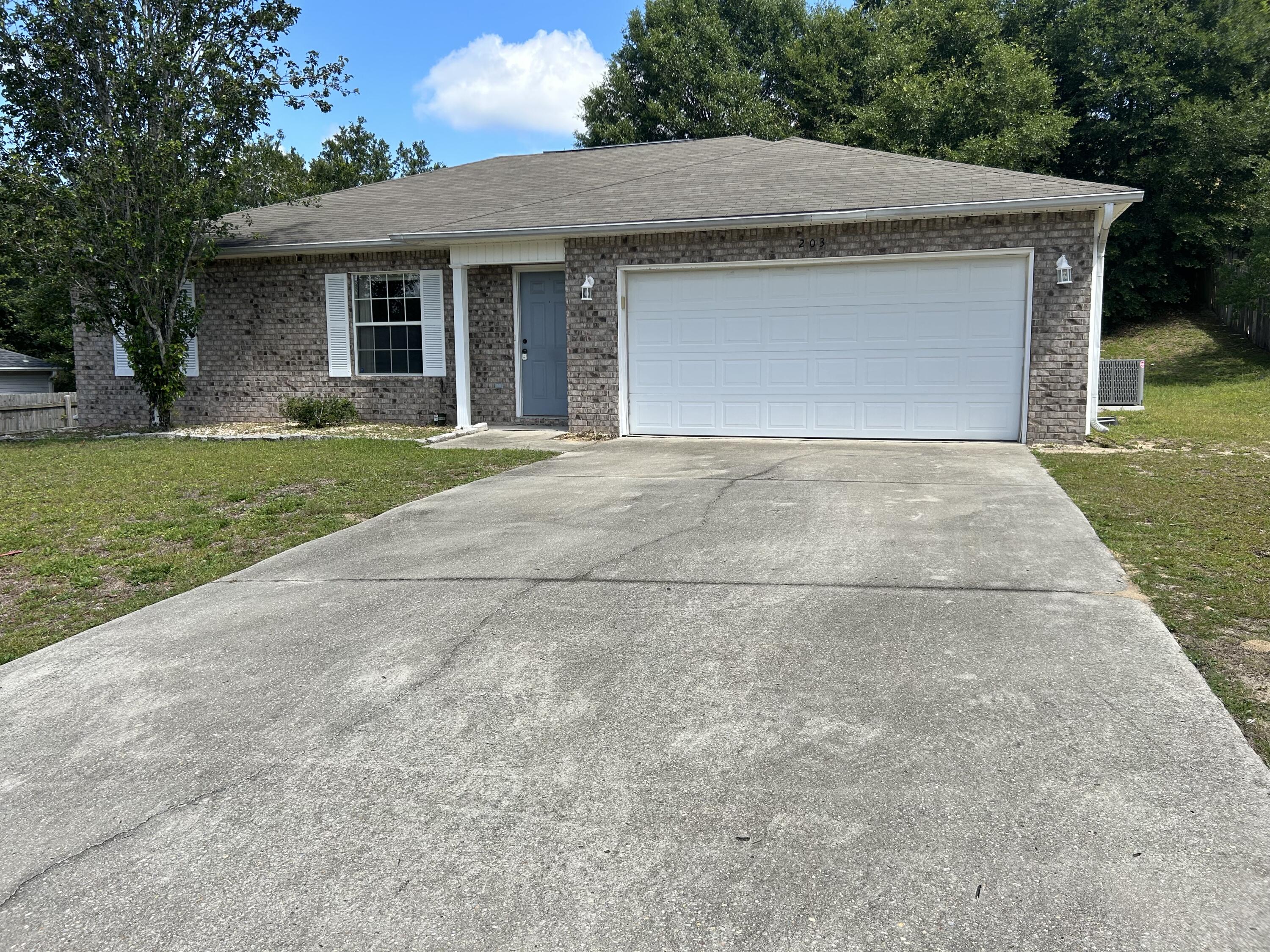 203 Cabana Way Crestview, FL 32536 - Photo 2 of 25 a front view of a house with a garden and yard