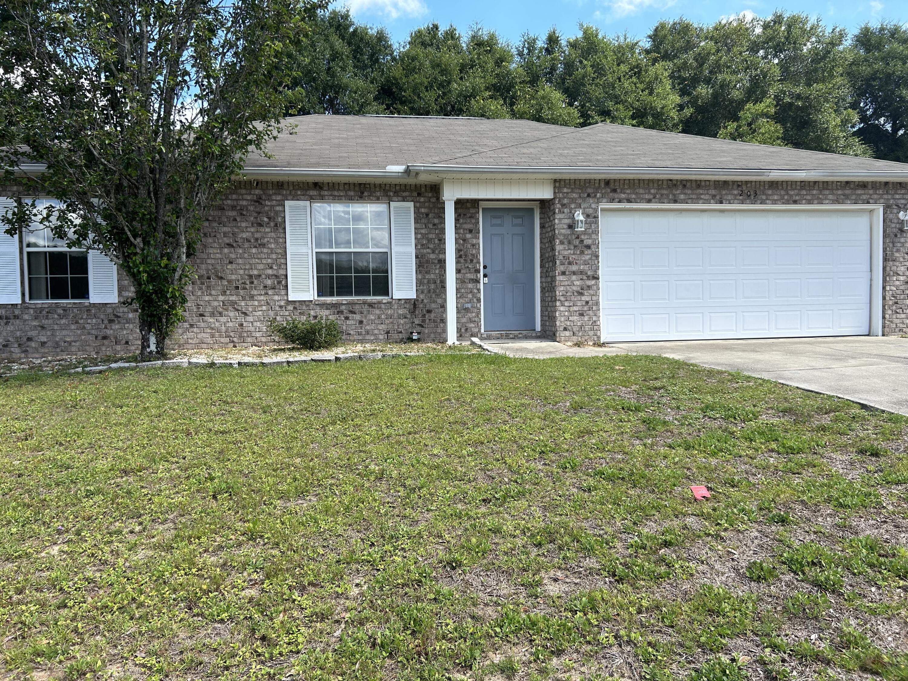 203 Cabana Way Crestview, FL 32536 - Photo 3 of 25 a front view of a house with a garden and yard