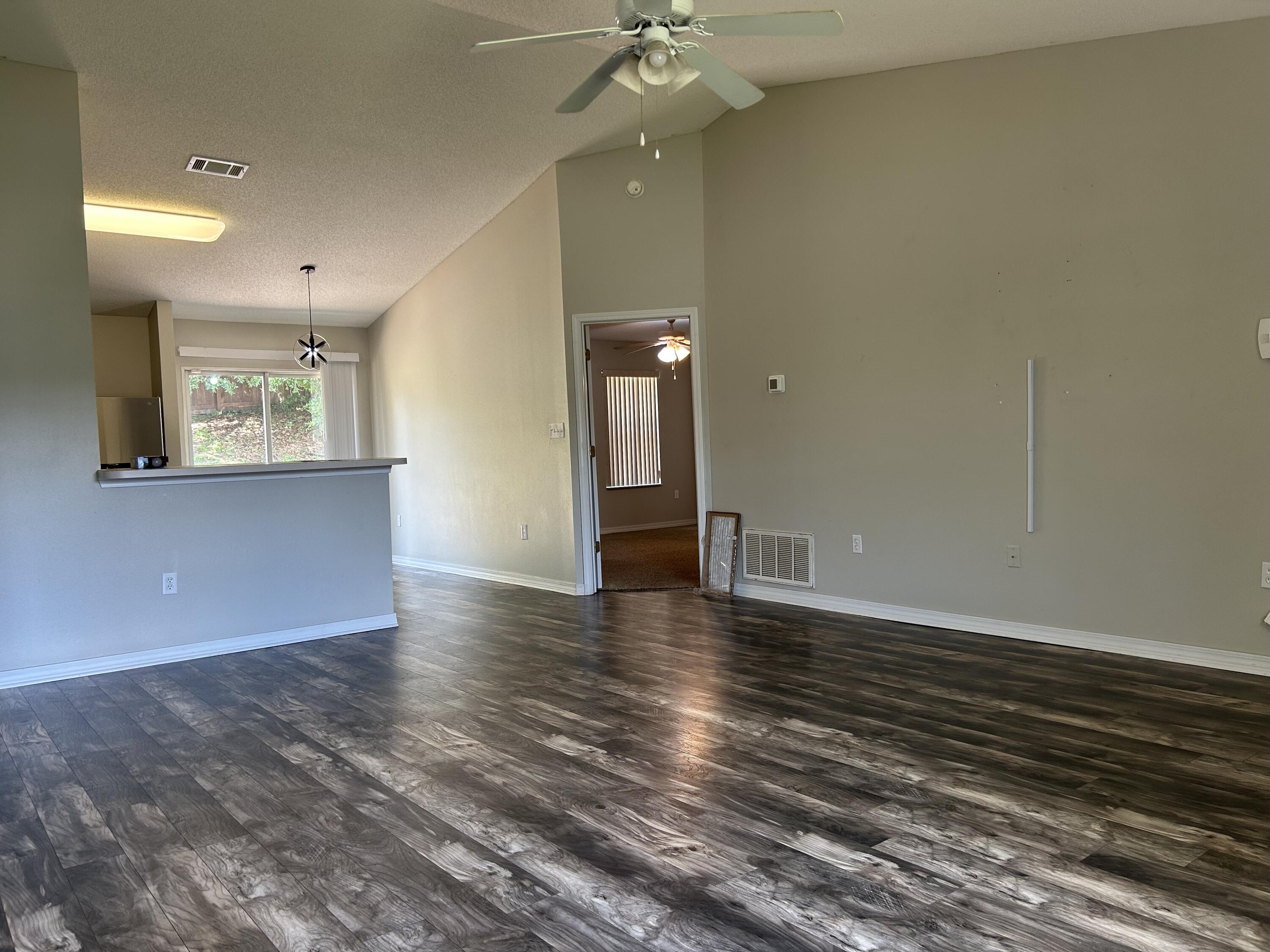 203 Cabana Way Crestview, FL 32536 - Photo 5 of 25 wooden floor in an empty room with a window