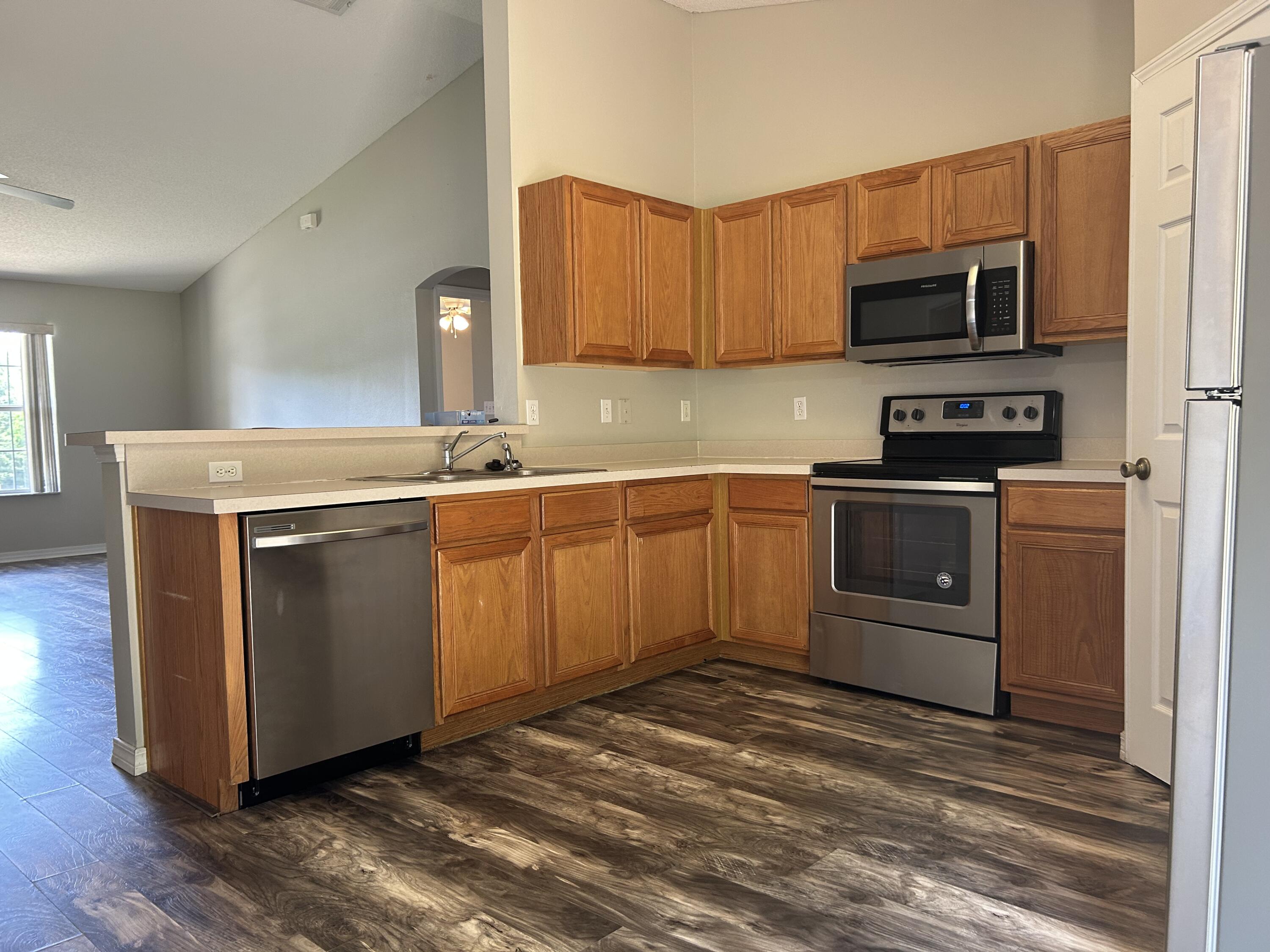 203 Cabana Way Crestview, FL 32536 - Photo 7 of 25 a kitchen with stainless steel appliances granite countertop a stove a sink and a microwave