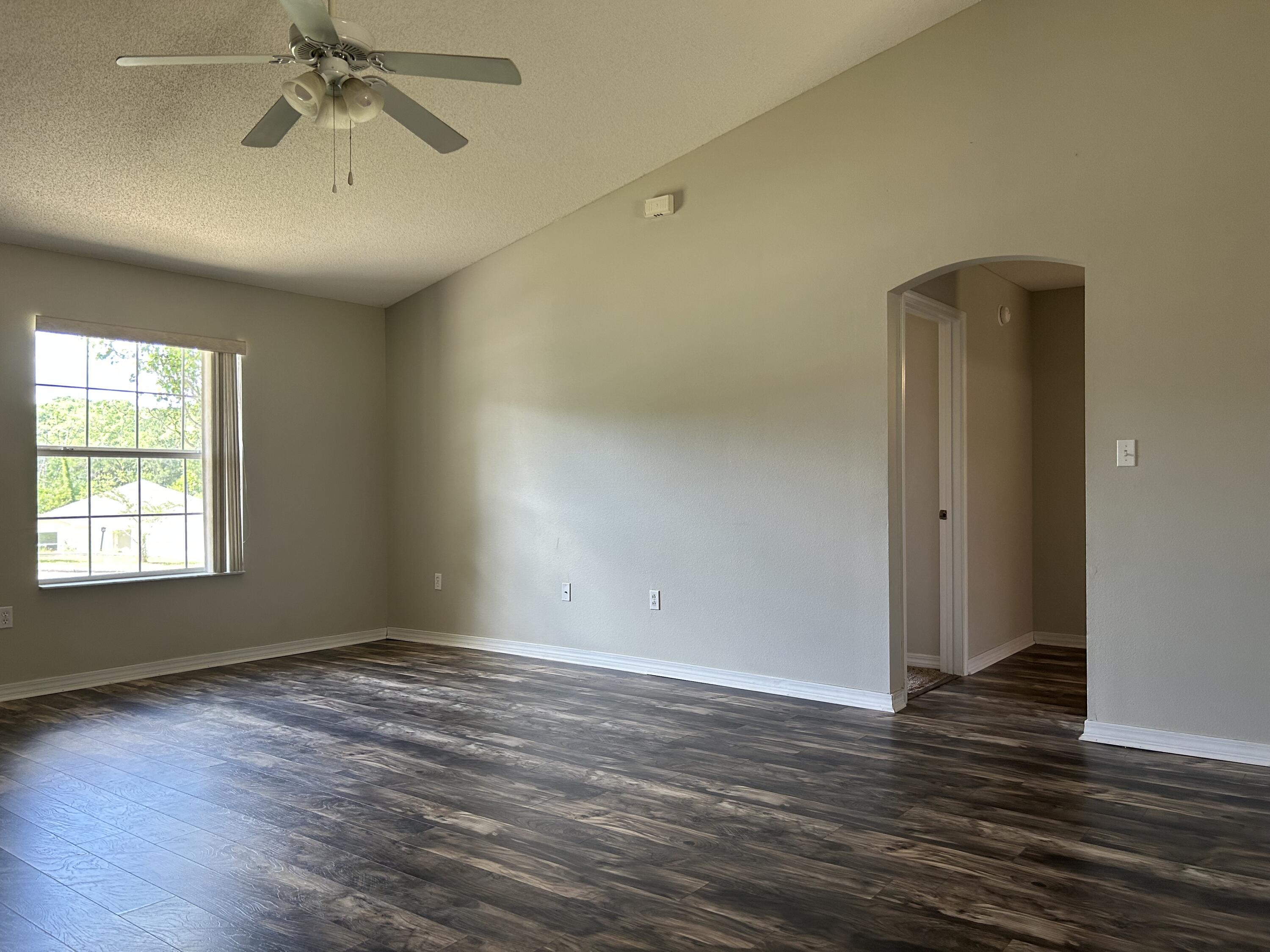 203 Cabana Way Crestview, FL 32536 - Photo 10 of 25 a view of an empty room with wooden floor and a window