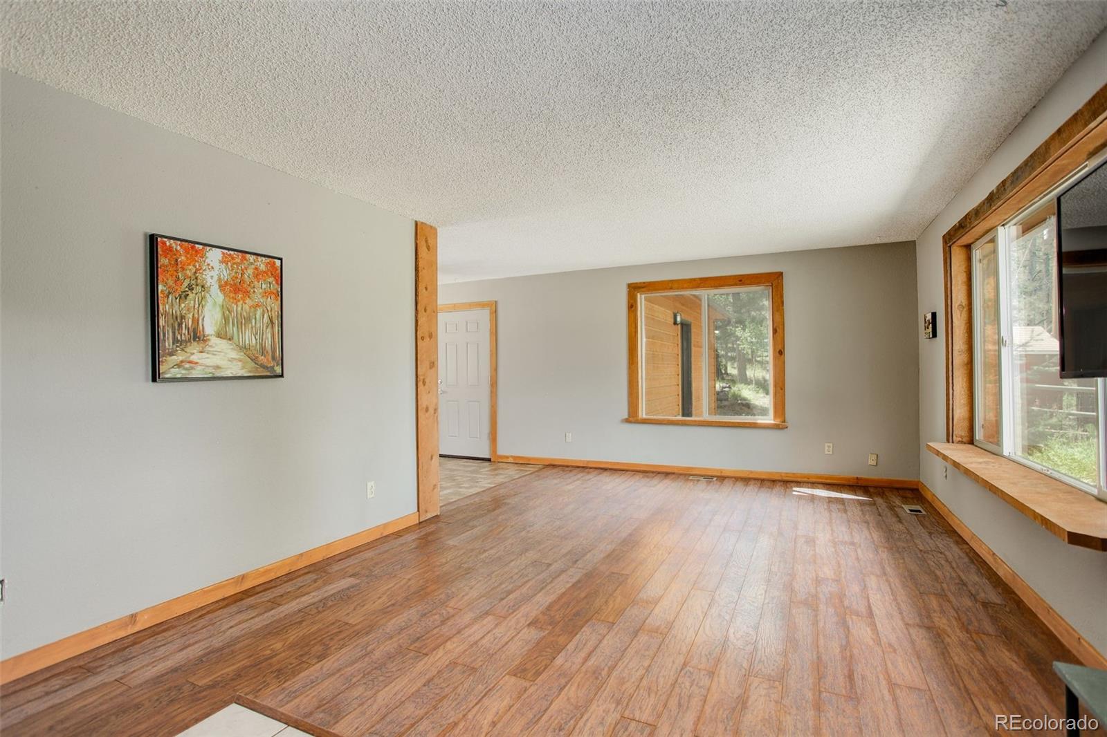 307 Hitchrack Road Bailey, CO 80421 - Photo 14 of 30 a view of an empty room with glass door and wooden floor