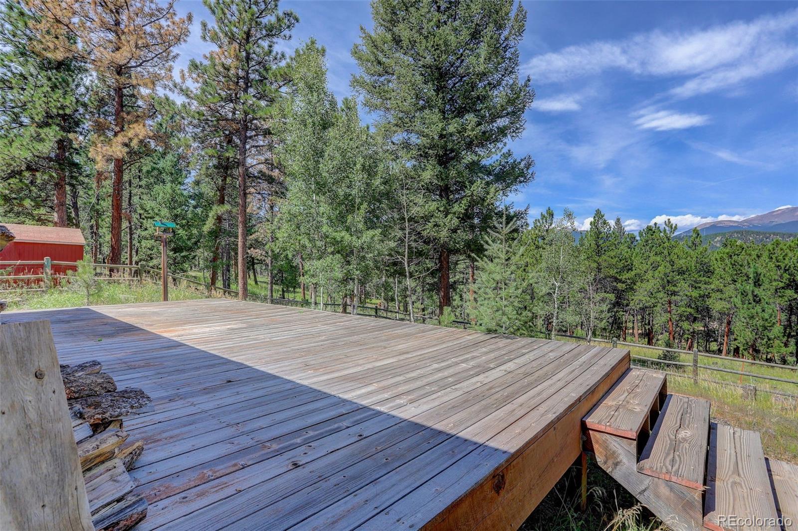 307 Hitchrack Road Bailey, CO 80421 - Photo 22 of 30 a view of a wooden floor with a table and chairs