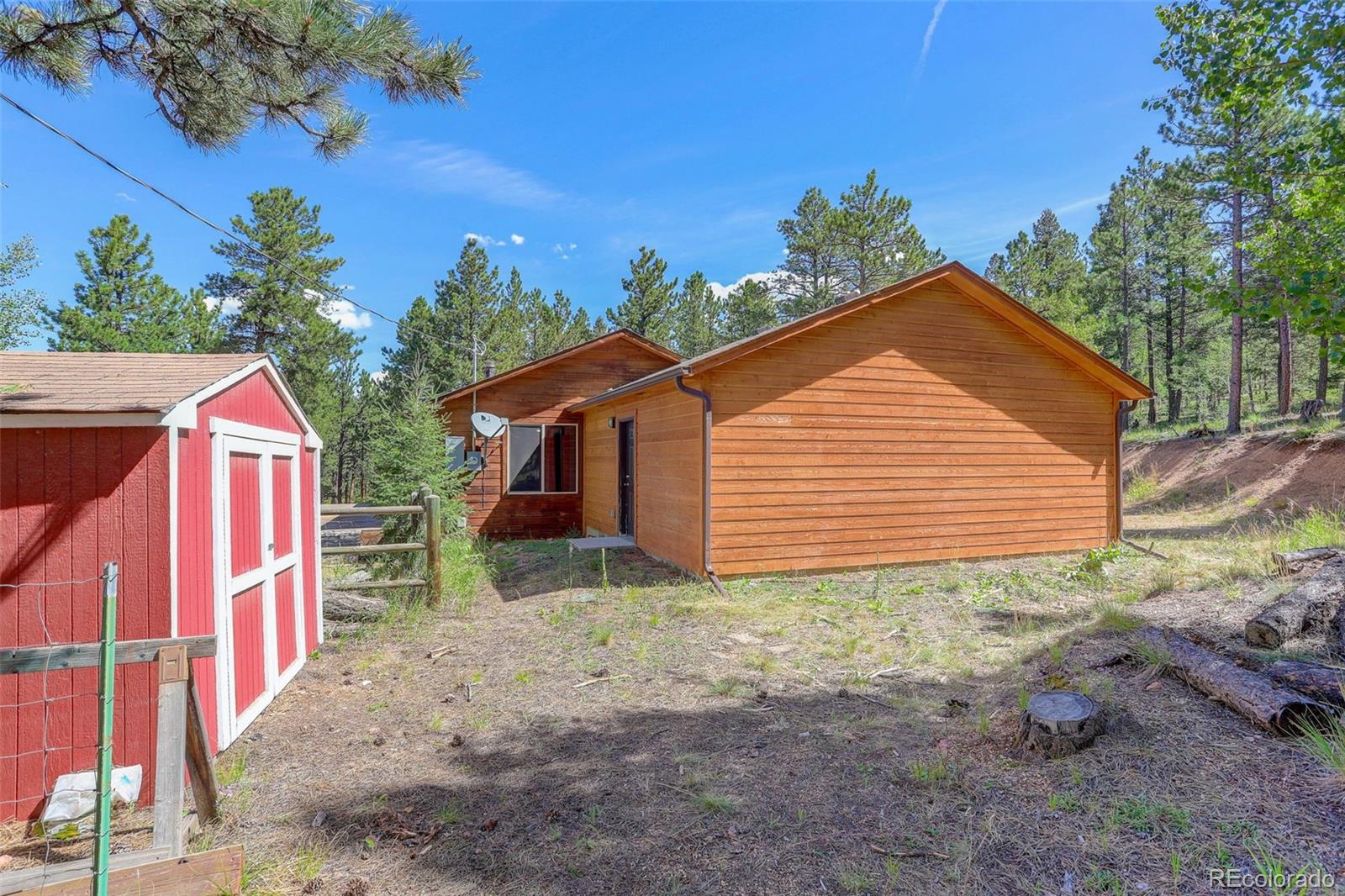 307 Hitchrack Road Bailey, CO 80421 - Photo 26 of 30 a view of a house with backyard and trees