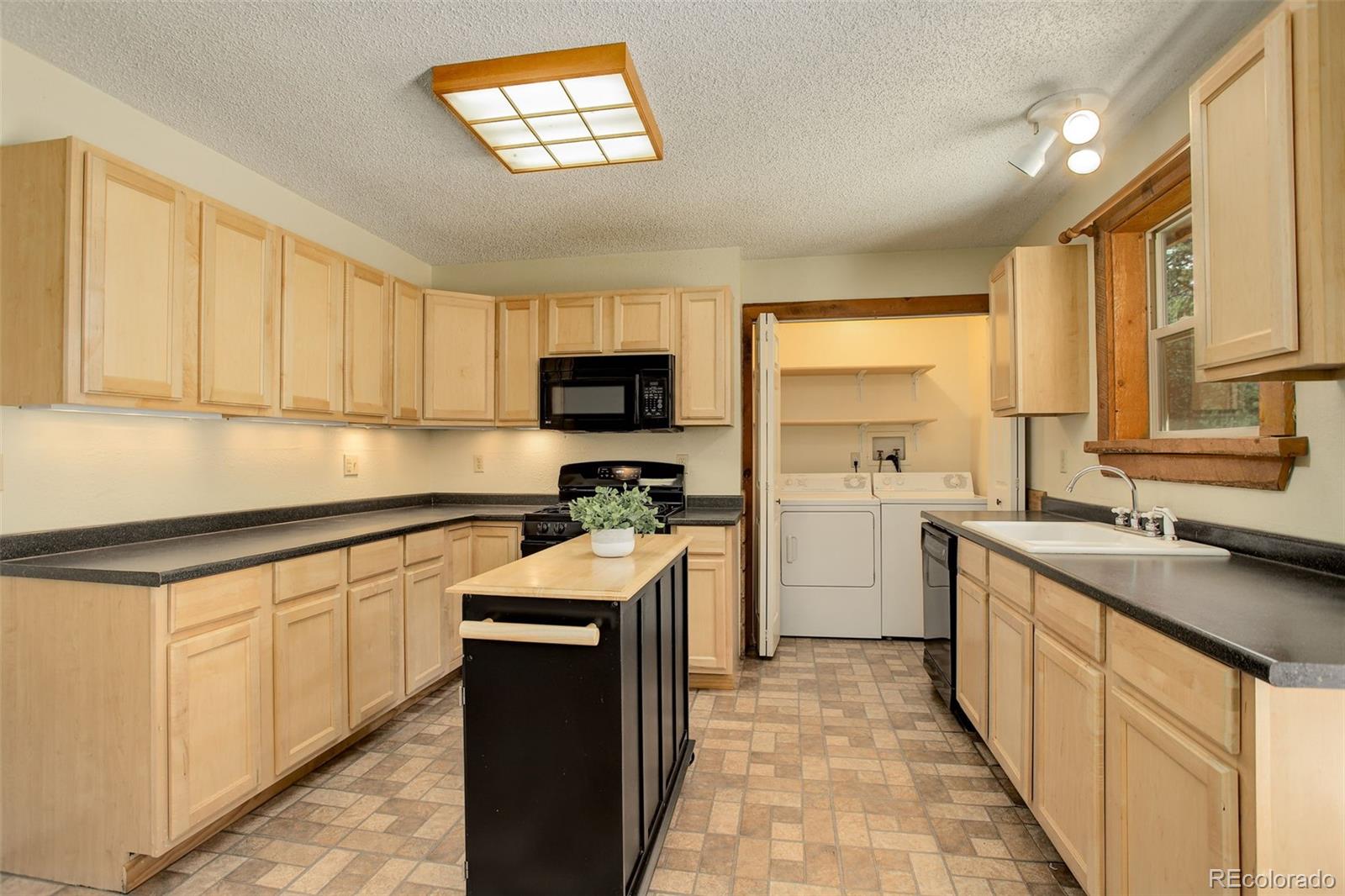 307 Hitchrack Road Bailey, CO 80421 - Photo 9 of 30 a kitchen with a sink stove and refrigerator