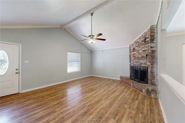 wooden floor in an empty room with a fireplace