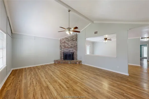 wooden floor in an empty room with a window