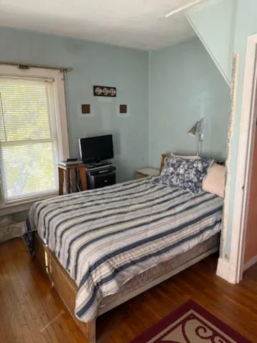 a bedroom with a bed and a flat tv screen