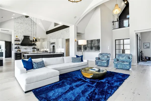 a living room with furniture and a view of kitchen
