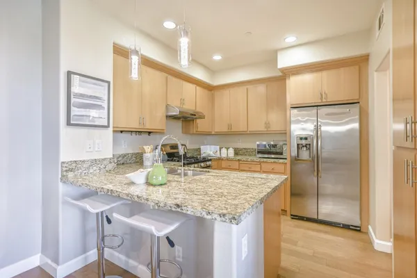 a kitchen with granite countertop white cabinets and white appliances