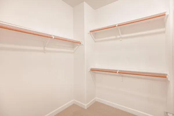 a bedroom with a bed table and a window