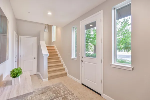 a view of a porch with a table and chairs