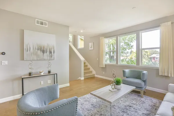 a living room with furniture and a potted plant