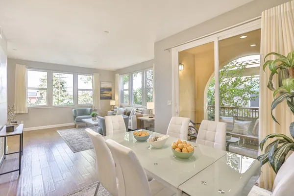 a balcony with furniture and a potted plant