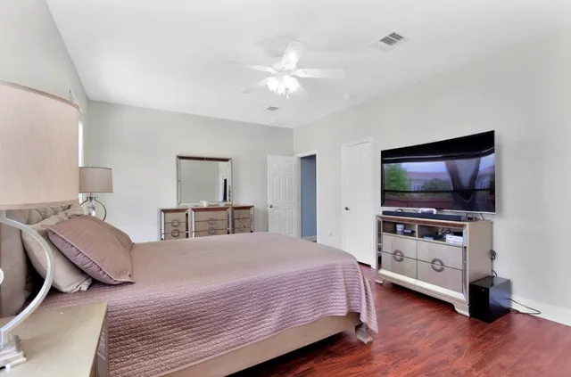 a bedroom with a bed and a flat screen tv