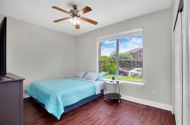 a bedroom with a bed a table and a window