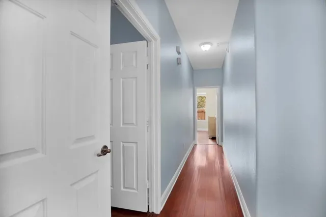 a view of a hallway with wooden floor