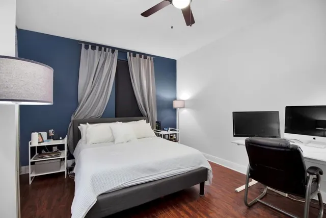 a bedroom with a bed and a flat screen tv