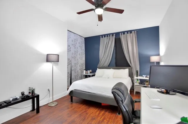 a bedroom with a bed and a chandelier