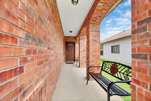a view of a patio with a table and chairs