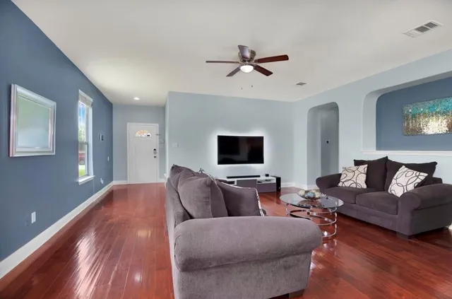 a living room with furniture and a flat screen tv
