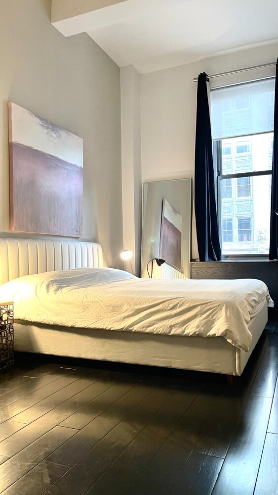254 Park Avenue South, Unit 6A Manhattan, NY 10010 - Photo 6 of 9 a large bed sitting in a bedroom next to a window