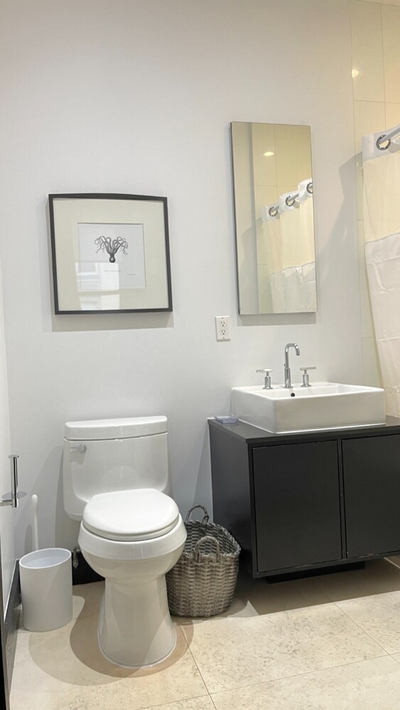 254 Park Avenue South, Unit 6A Manhattan, NY 10010 - Photo 9 of 9 a bathroom with a toilet sink and mirror