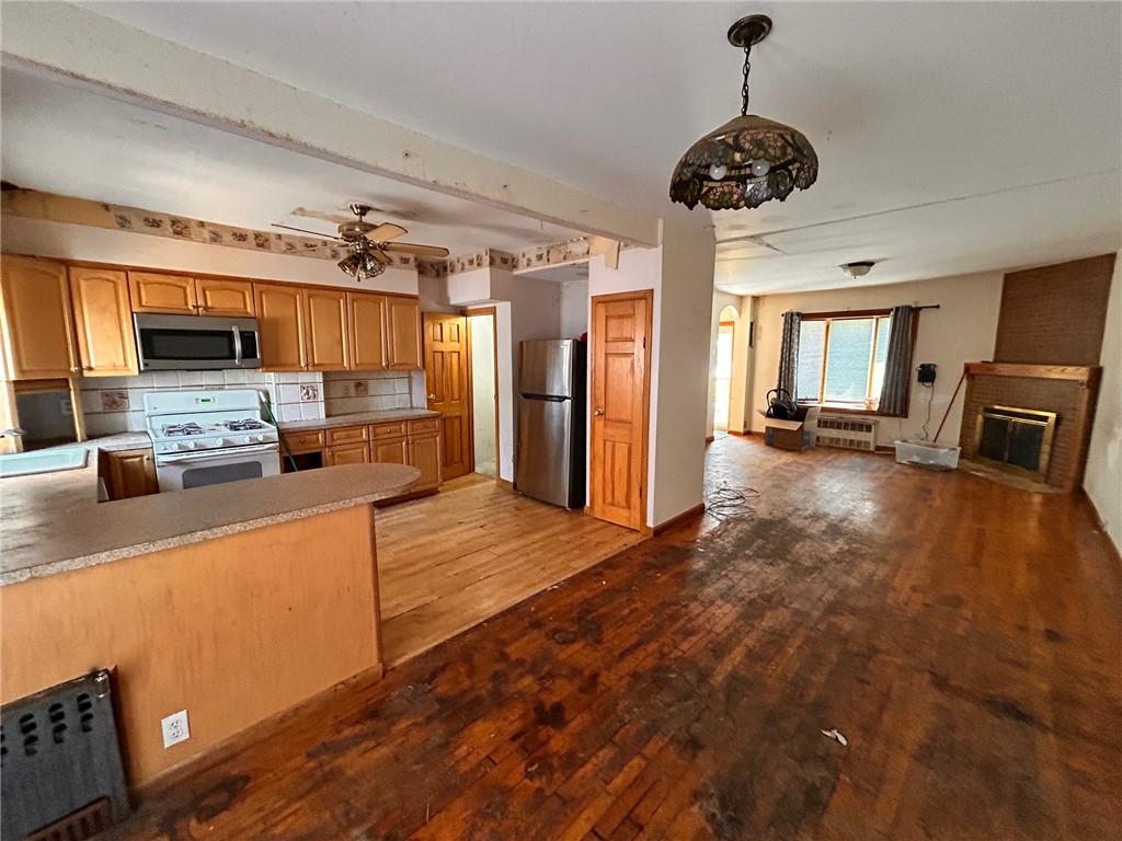 2016 Brown Street Brooklyn, NY 11229 - Photo 3 of 8 a kitchen with stainless steel appliances granite countertop a refrigerator a stove and a sink with cabinets