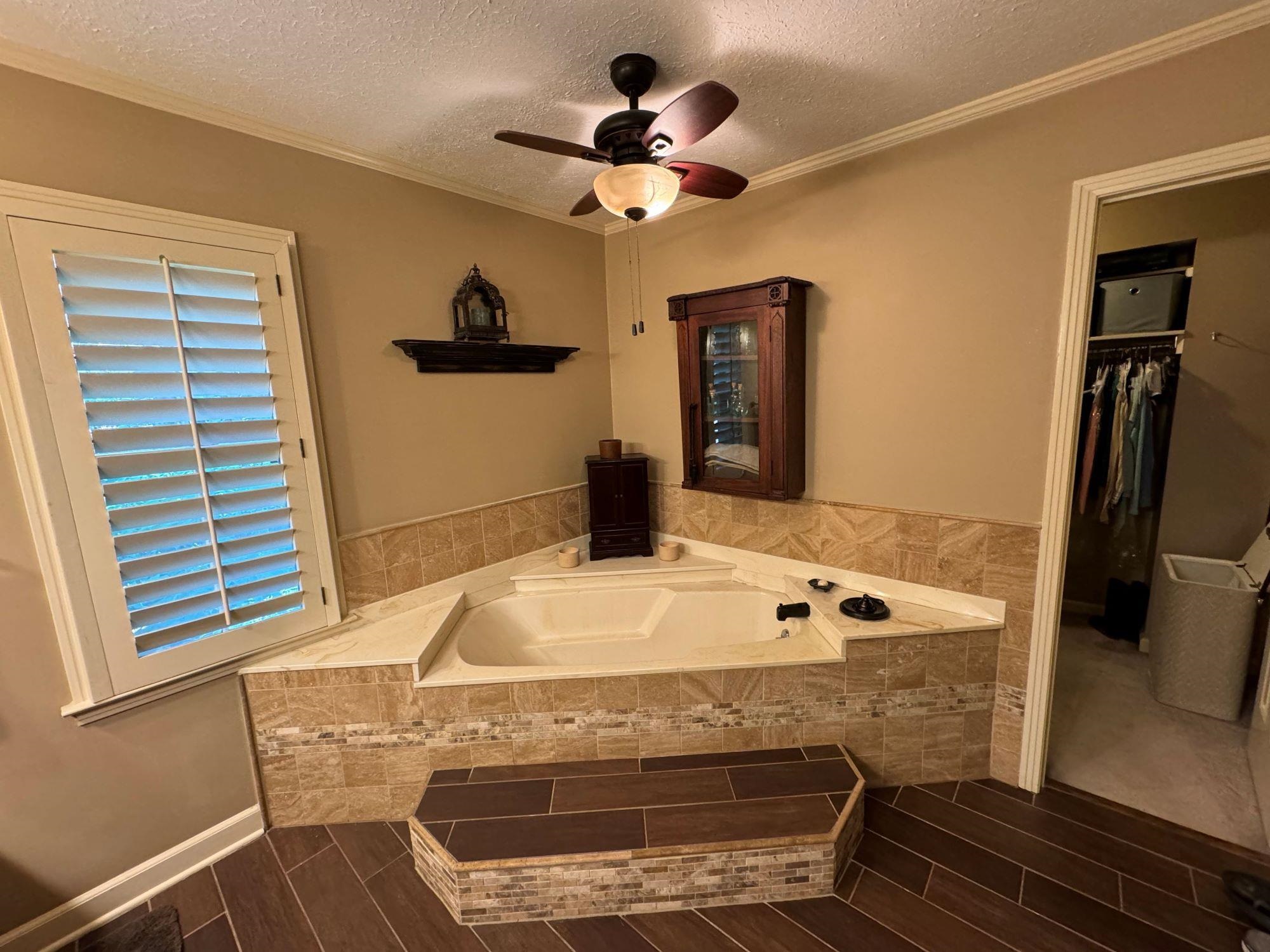 2695 Brook Bridge Cove Germantown, TN 38138 - Photo 18 of 40 Primary bath features soaker tub and wood tile flooring. Large walk-in closet