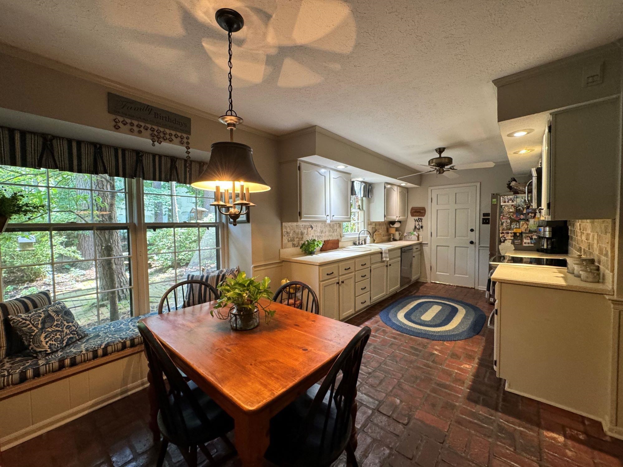 2695 Brook Bridge Cove Germantown, TN 38138 - Photo 6 of 40 Brick floors, stainless appliances. Smoothtop range has 2 ovens. New dishwasher and fridge. Window above sink overlooks courtyard.