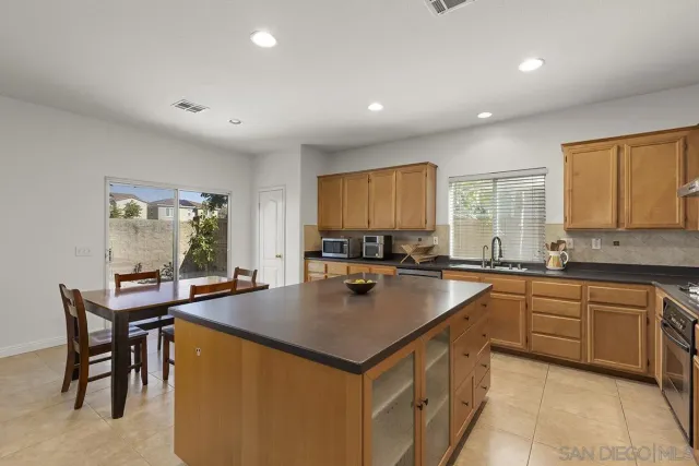 a kitchen with a table and chairs in it