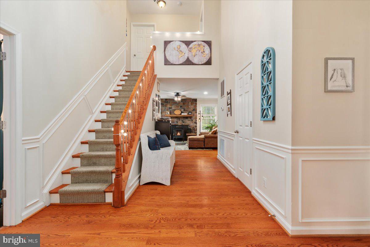 220 Deerhaven Road Front Royal, VA 22630 - Photo 6 of 34 a view of a hallway with wooden floor and staircase