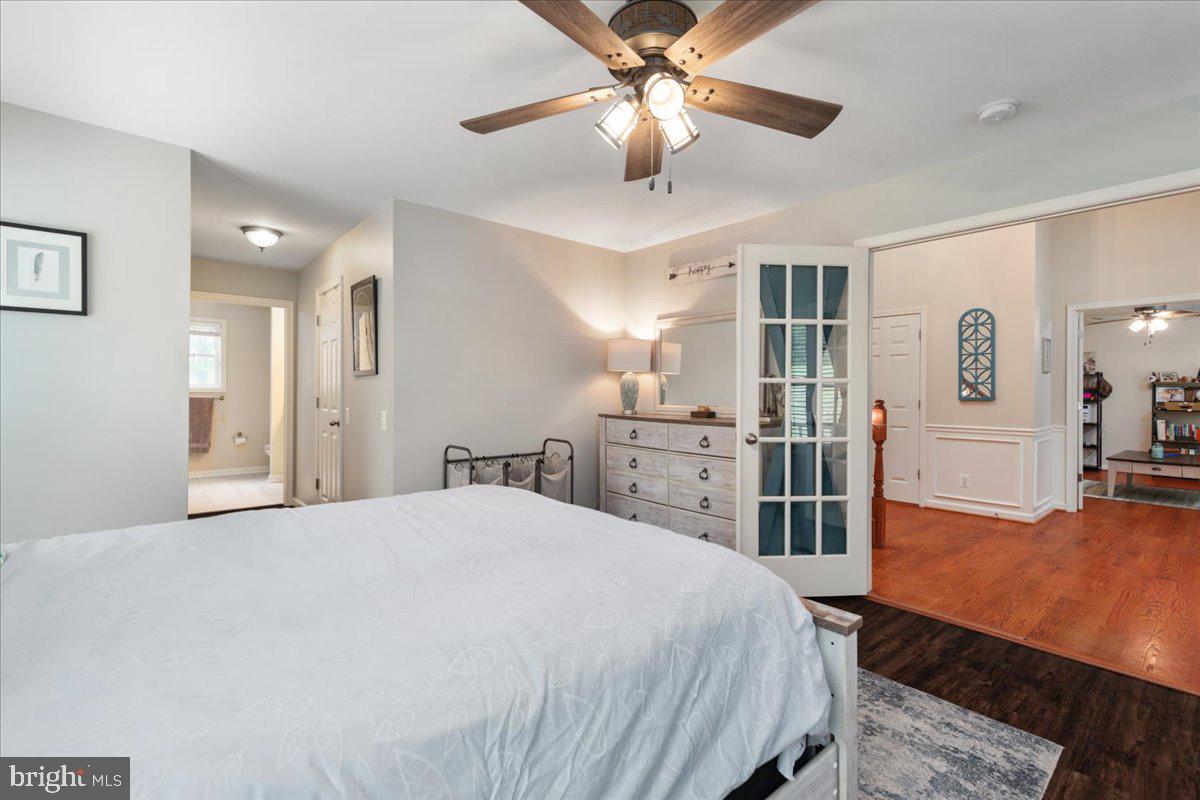 220 Deerhaven Road Front Royal, VA 22630 - Photo 10 of 34 a spacious bedroom with a bed and a chandelier