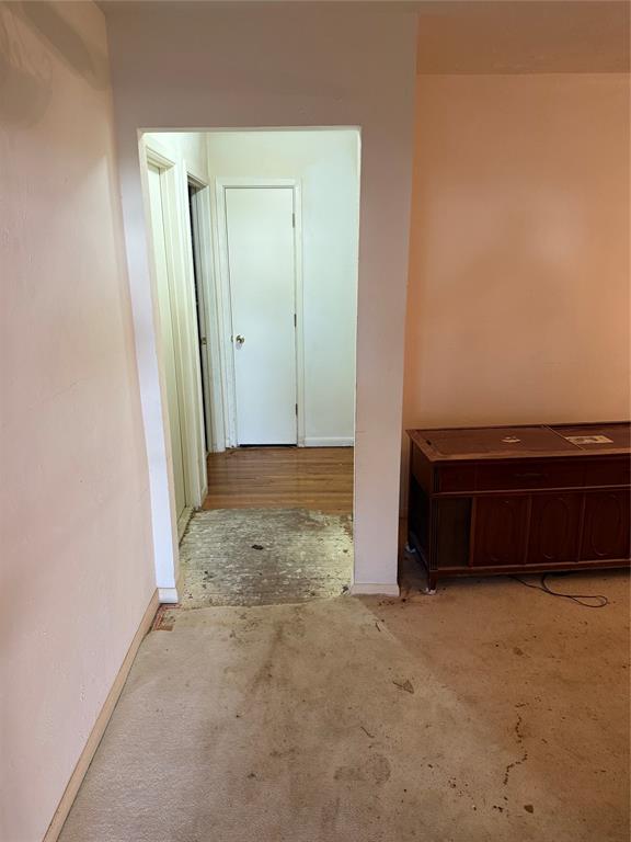 12039 Schroeder Road Dallas, TX 75243 - Photo 2 of 29 an empty room with a bench and a wooden floor