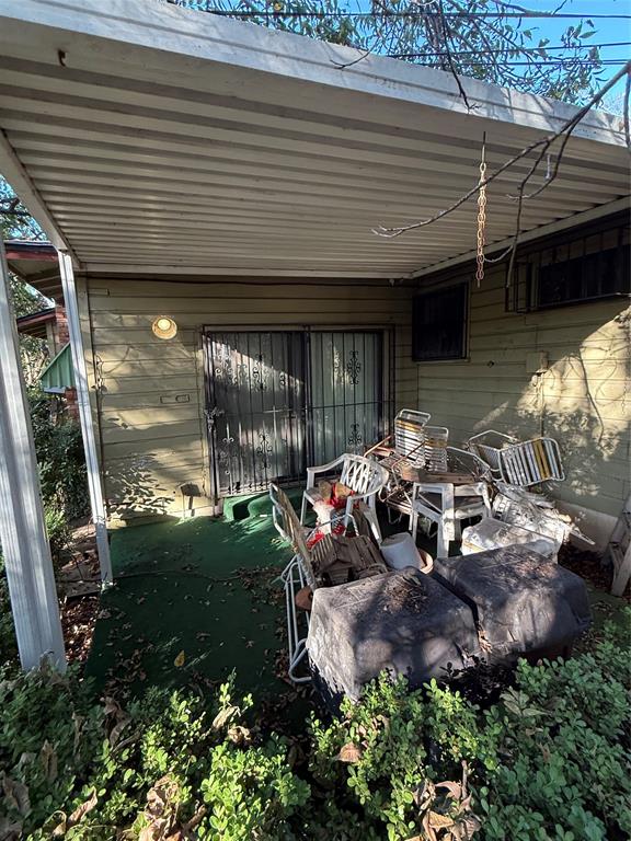 12039 Schroeder Road Dallas, TX 75243 - Photo 22 of 29 a view of a patio with table and chairs potted plants and floor to ceiling window
