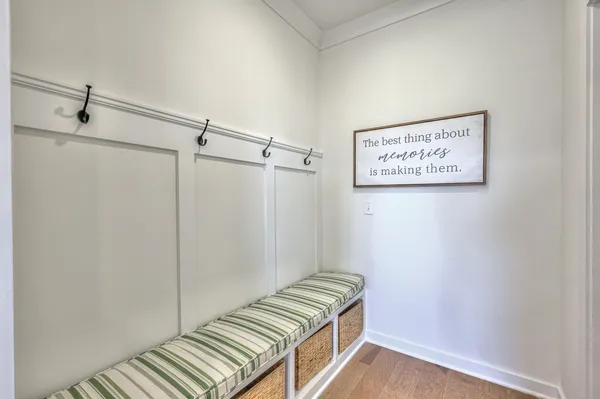 a kitchen with a dining table chairs wooden floor and appliances