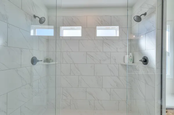 a bathroom with a sink toilet a mirror and shower