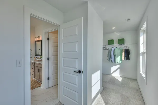 a spacious bedroom with a bed and a window