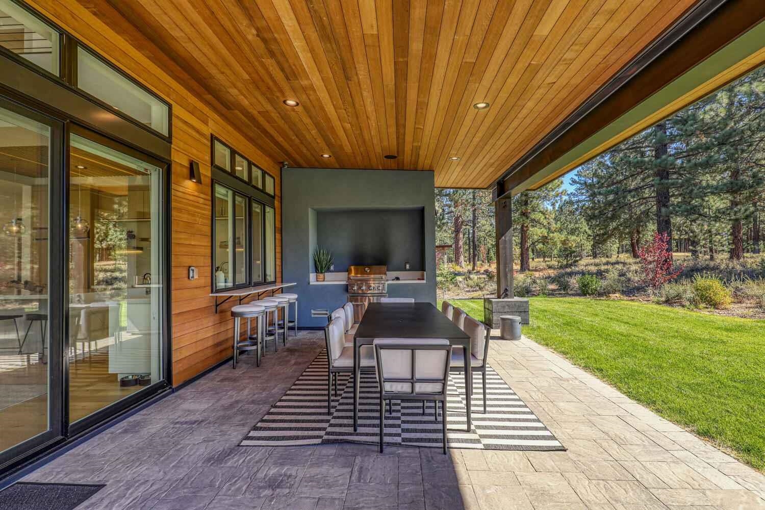 11614 Henness Road, Unit SHARE B Truckee, CA 96161 - Photo 18 of 28 a view of a patio with table and chairs with wooden floor and fence