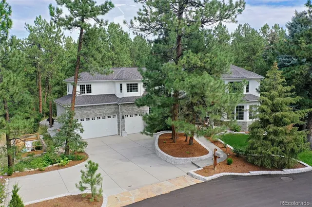 a view of a backyard with table and chairs and potted plants