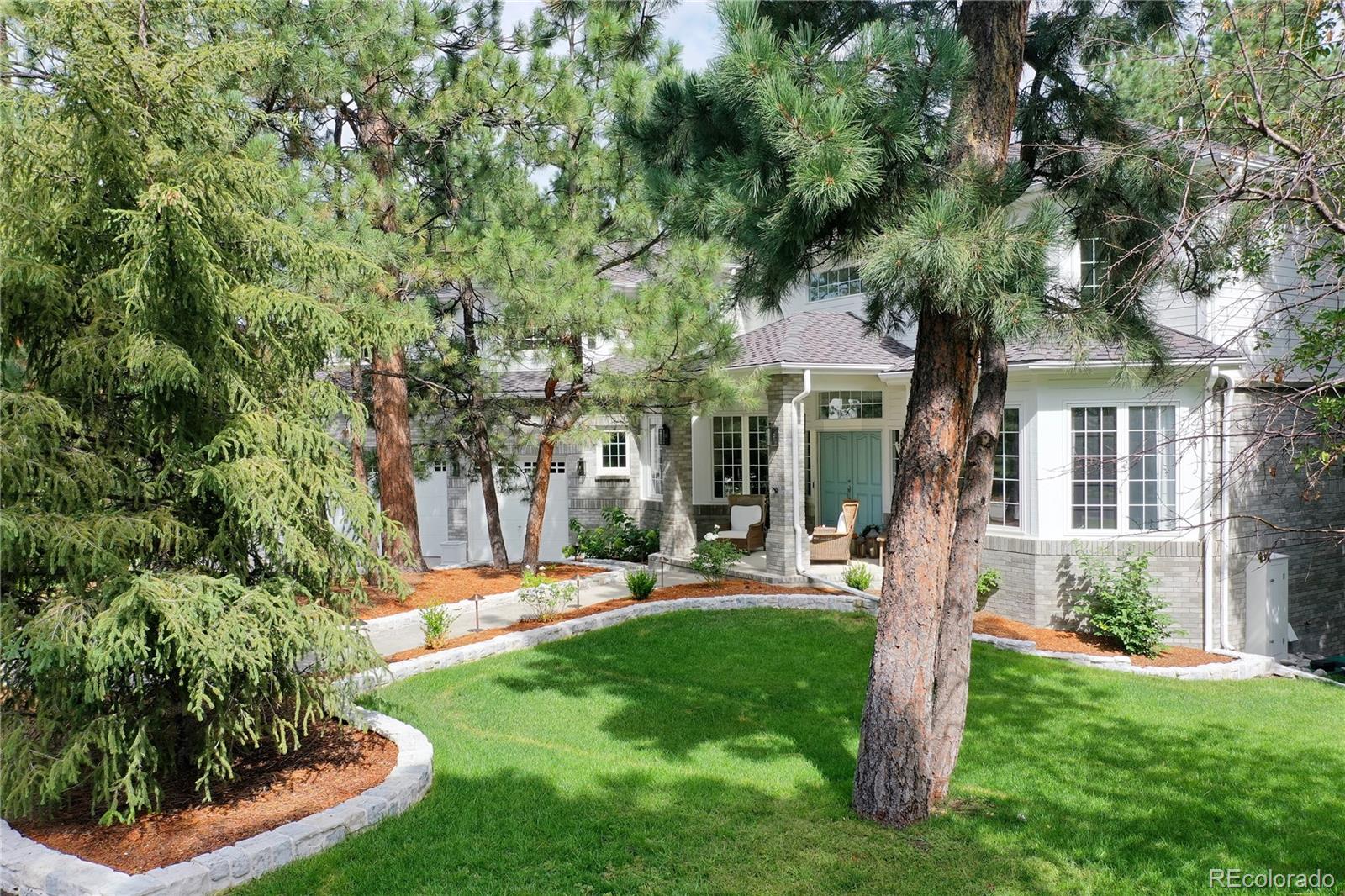 475 Silbrico Way Castle Rock, CO 80108 - Photo 2 of 50 a front view of a house with a yard and palm trees