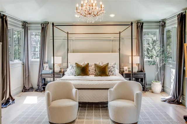 a living room with furniture a window and a chandelier