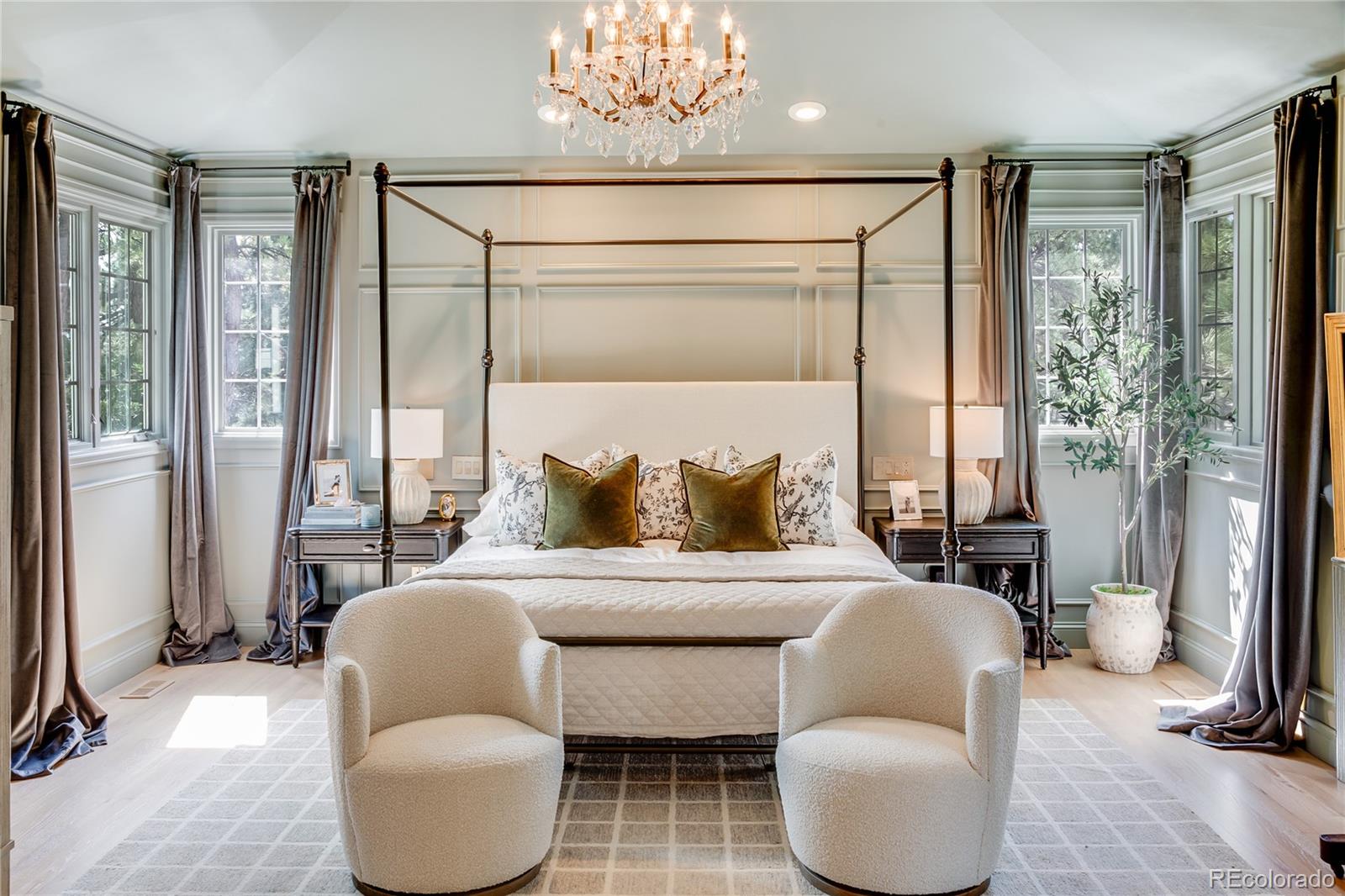 475 Silbrico Way Castle Rock, CO 80108 - Photo 31 of 50 a bedroom with a bed and a chandelier